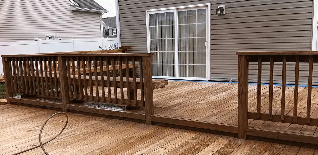 Deck sealing service protecting a backyard wood deck and railings in Lakeland, FL