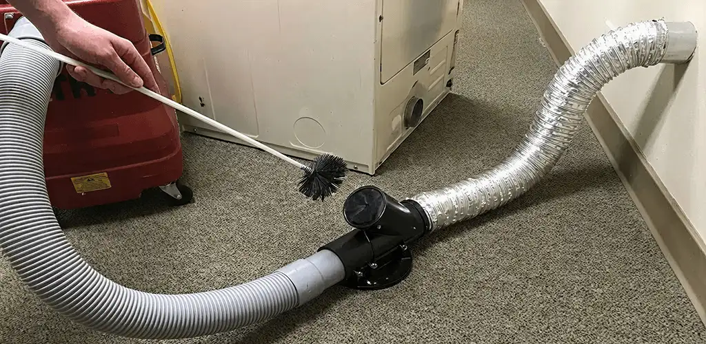 Dryer vent cleaning service removing lint from a dryer duct connection in Lakeland, FL
