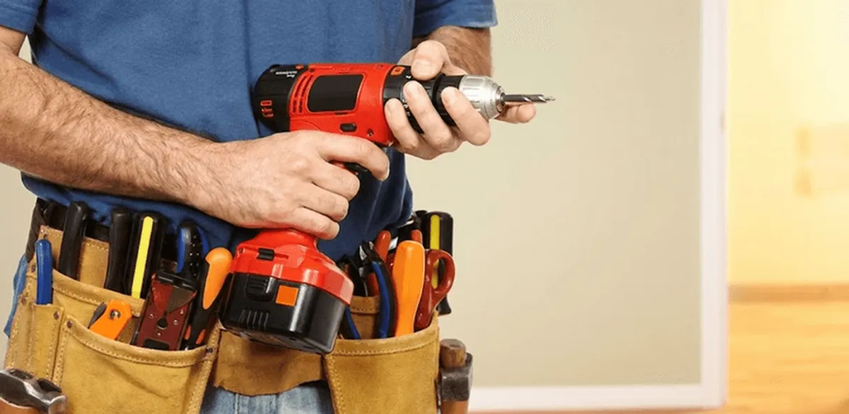 Handyman holding a power drill for home repairs and installations in Lakeland, FL