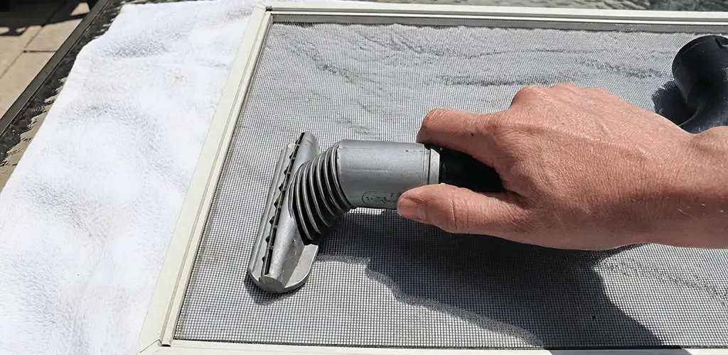 Window screen repair cleaning and fixing a damaged screen mesh in Lakeland, FL